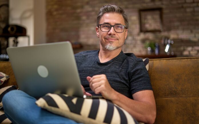 Man working with laptop at home office